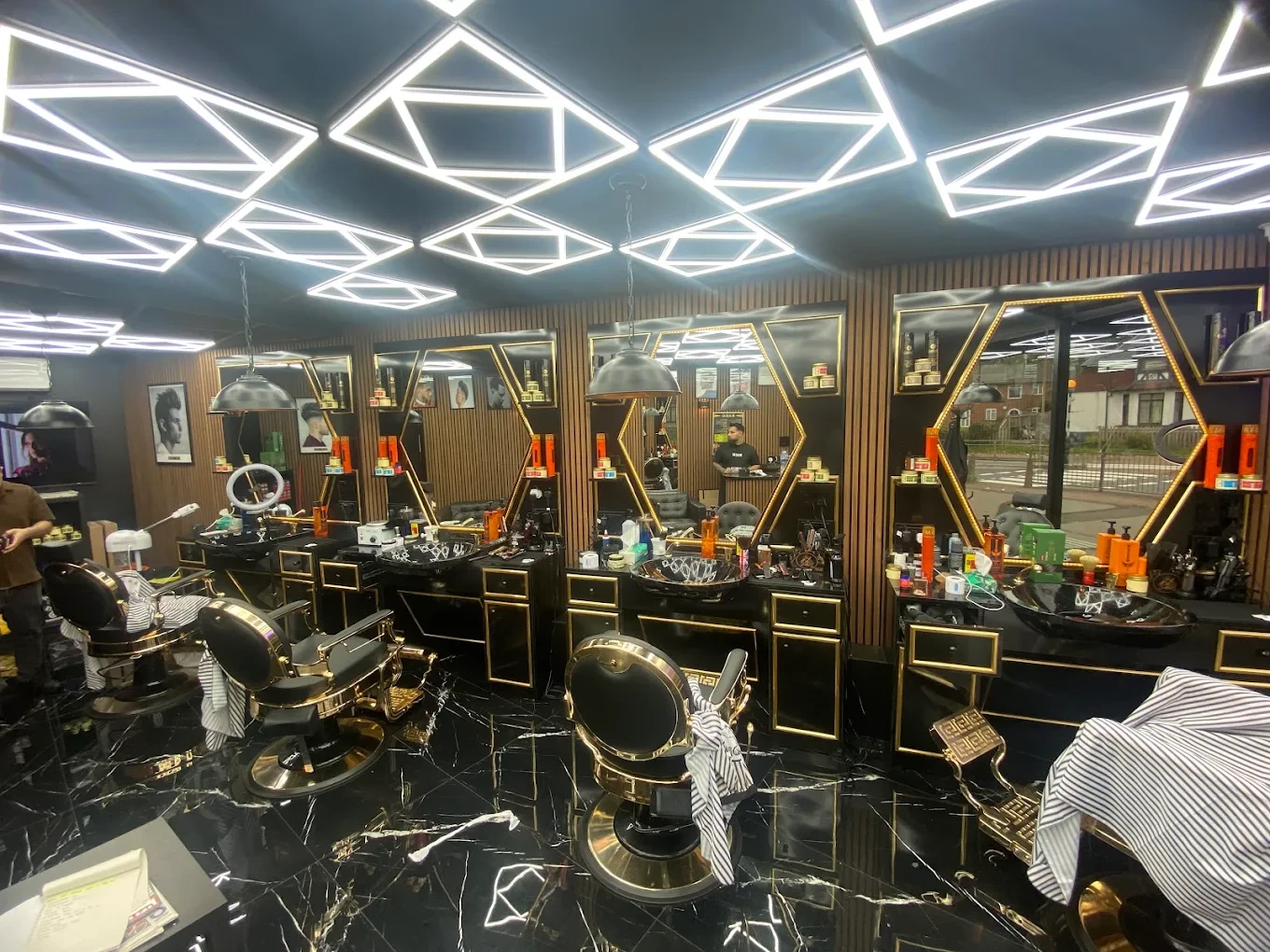 Row of barber chairs on the black marble floor