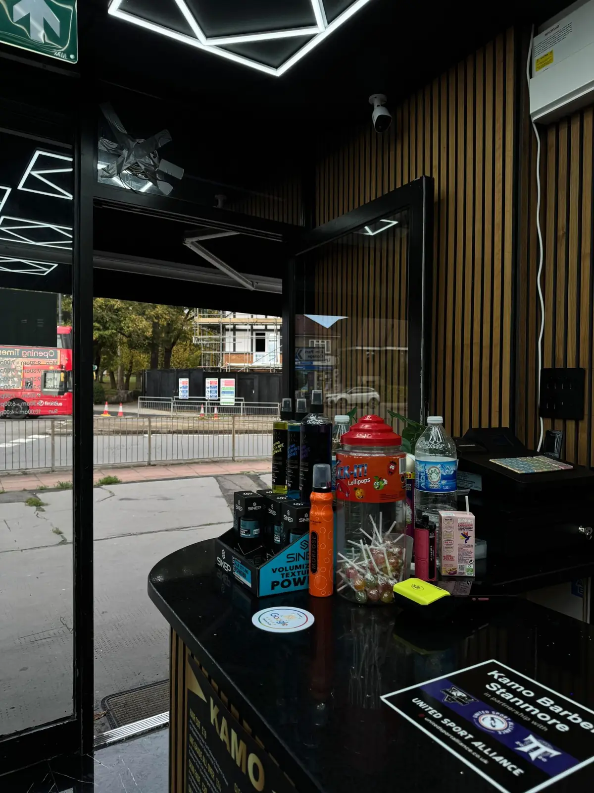 Front counter with styling products and a lollipop jar