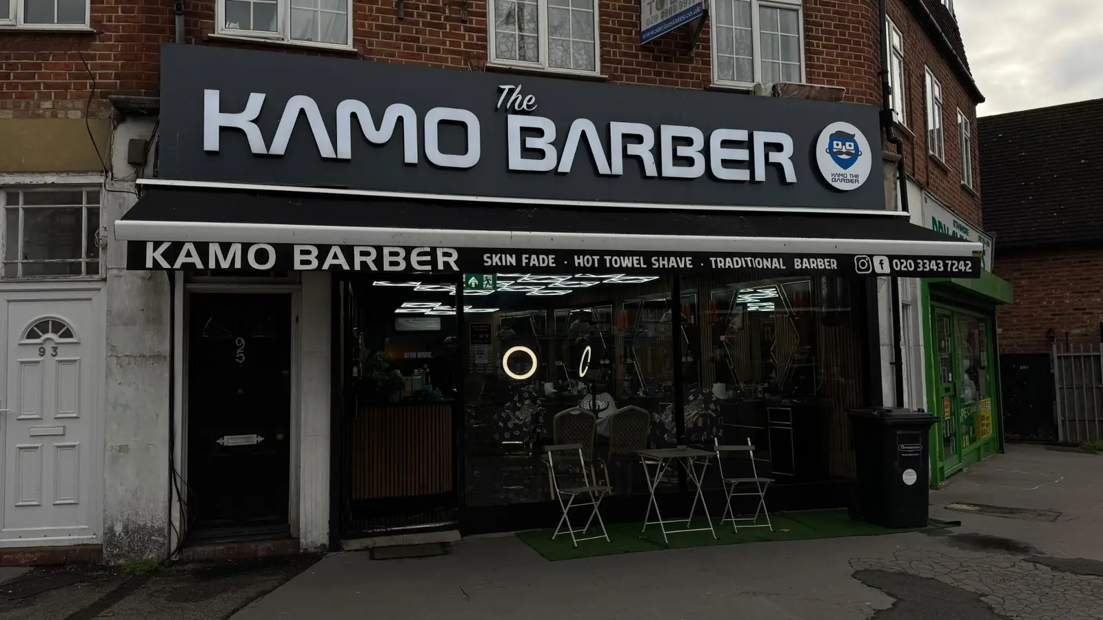 The Kamo Barber shopfront with black signage reading Skin fade, Hot towel shave, Traditional barber