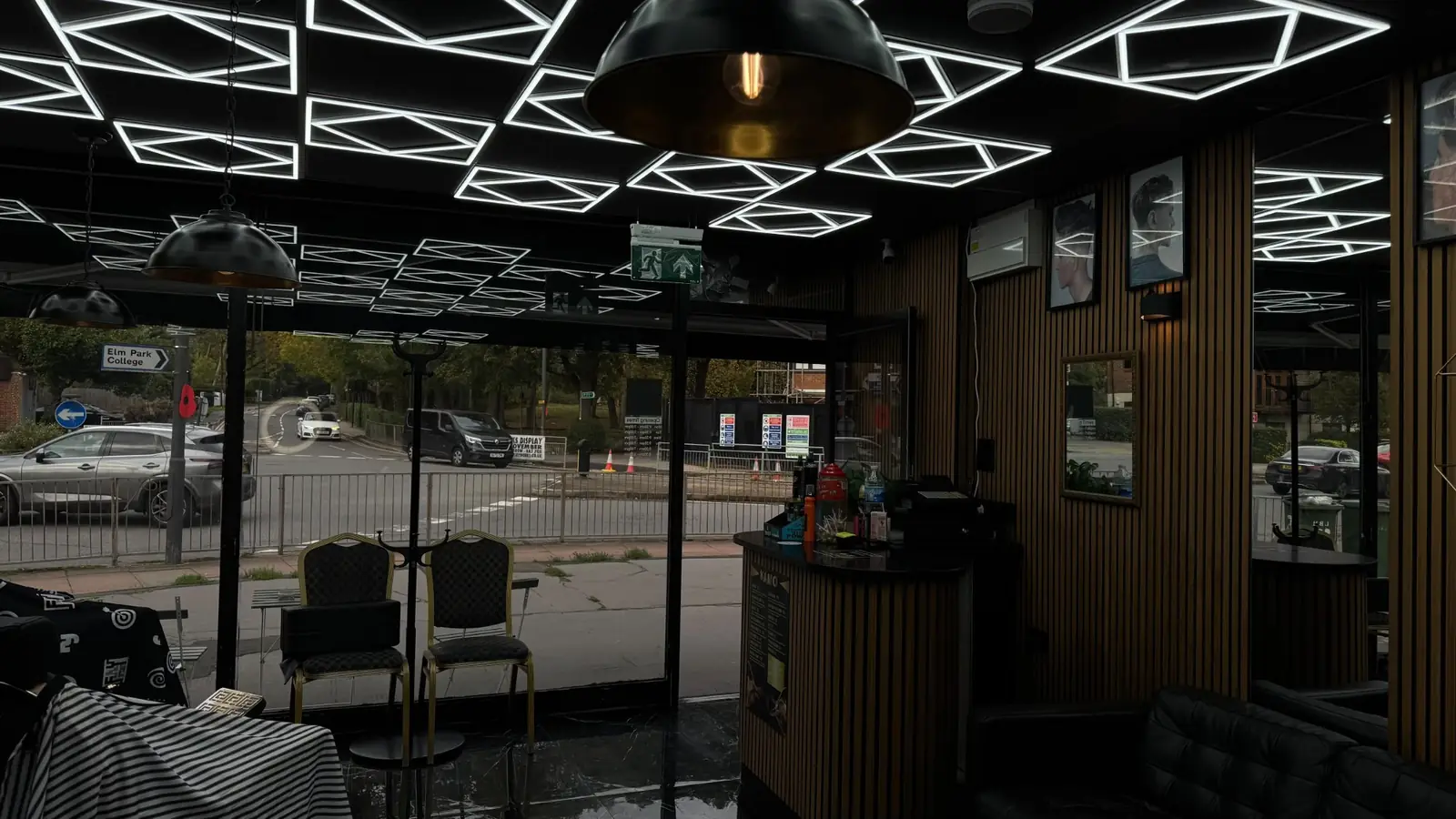 Front of the shop with LED ceiling lights, chairs and the counter